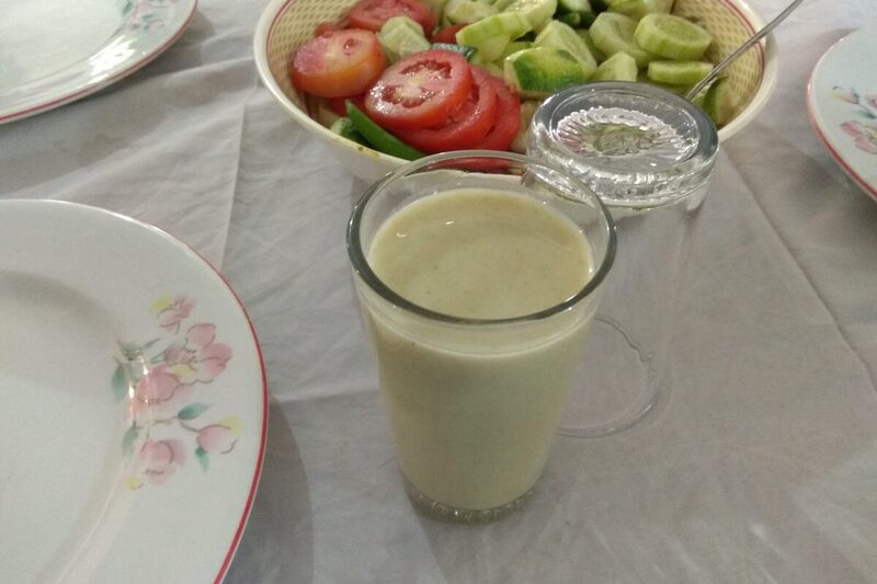 Glass of pale, creamy Borhani, a spiced Bangladeshi yogurt drink