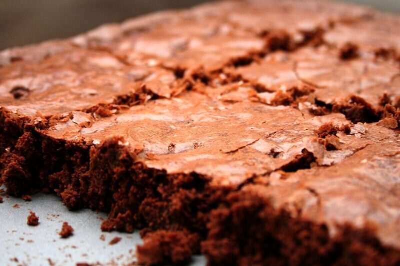 Stack of fudgy chocolate brownies with a crackly top