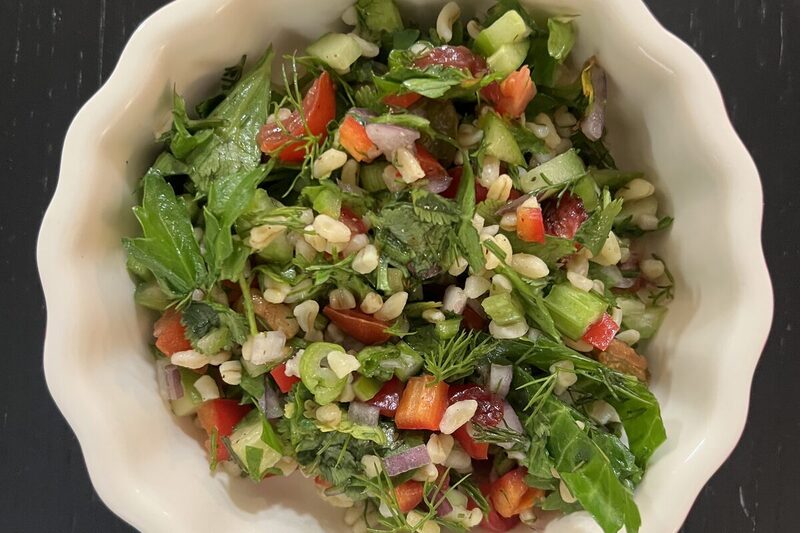 Bowl of Lebanese tabbouleh, mostly finely chopped parsley with bulgur and tomato