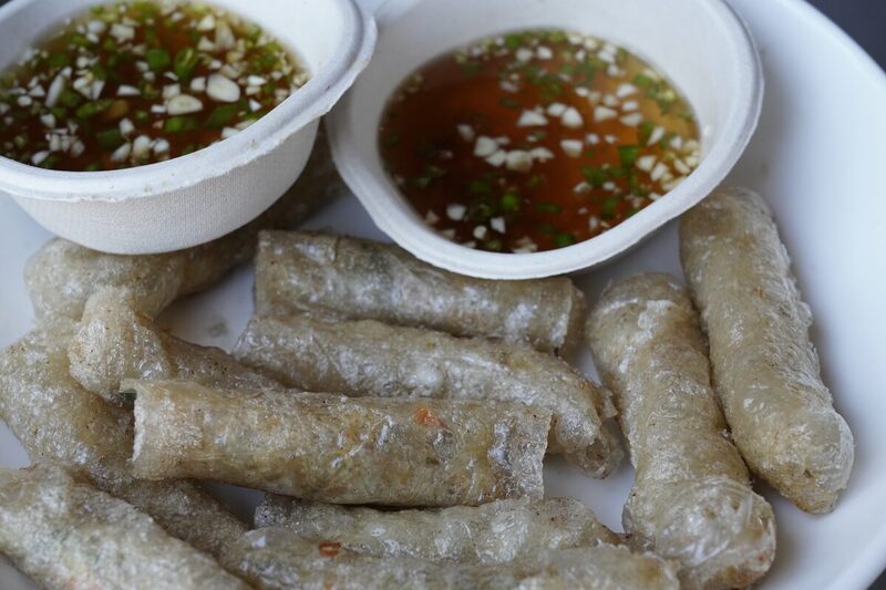 Fried Vietnamese spring rolls served with lettuce, herbs, and dipping sauce